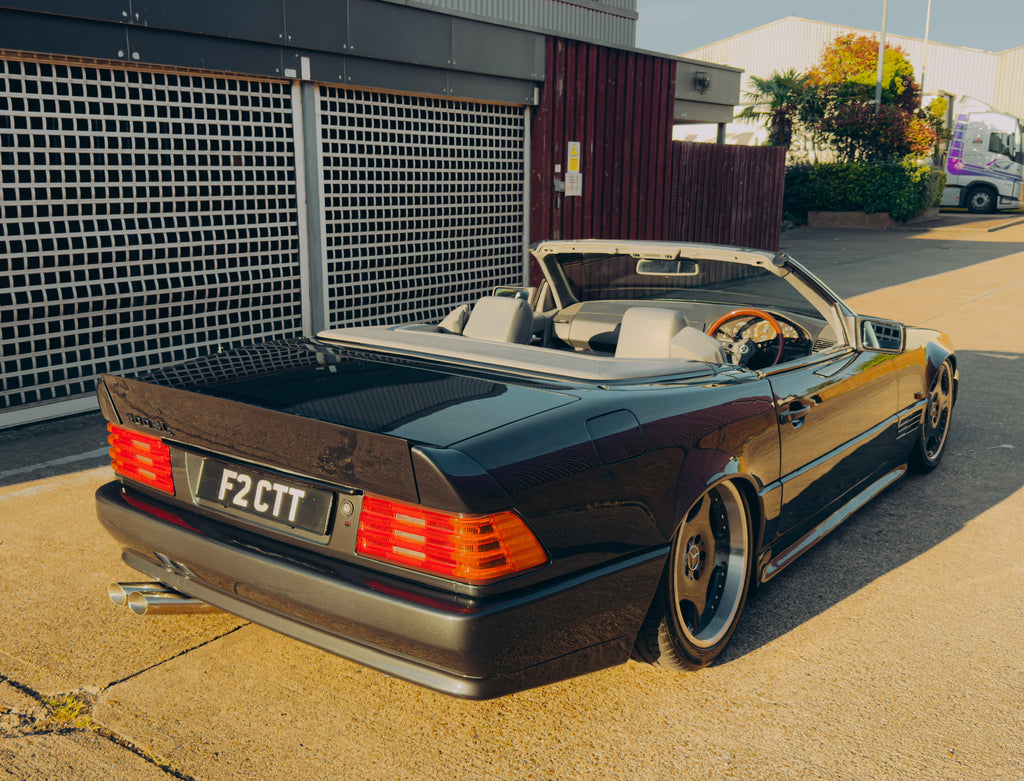 Mercedes-Benz R129 SL convertible, rear three-quarter view with roof down